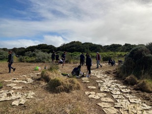 Students assisting Warrnambool Coastcare Landcare with tree planting at the Flume.