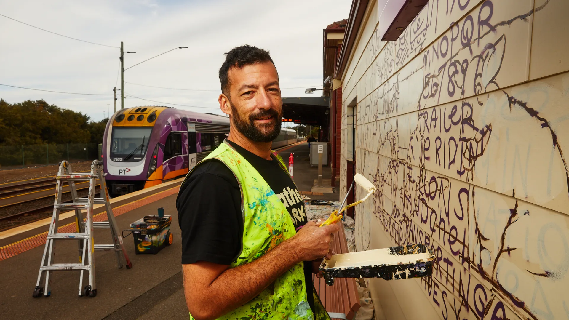 Tyson Savanah aka “Father Marker” painting a mural in Warrnambool