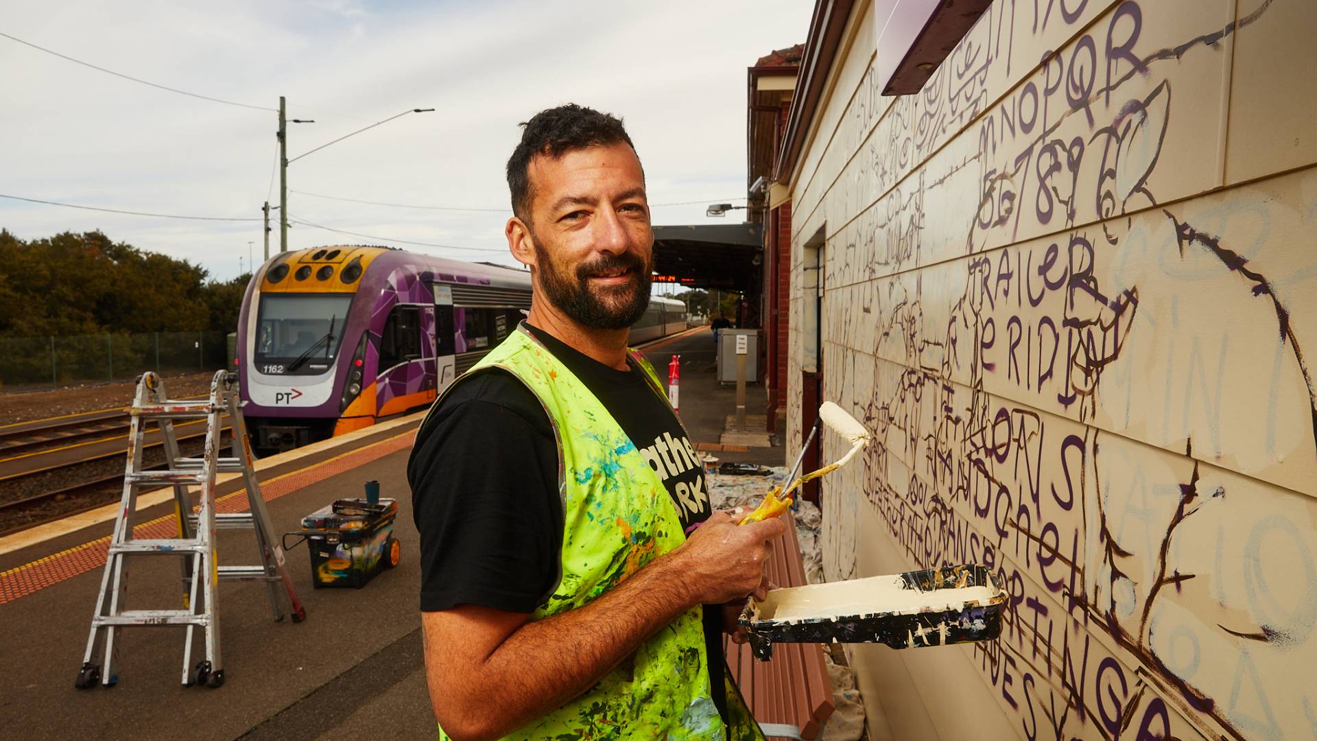 Tyson Savanah aka “Father Marker” painting a mural in Warrnambool
