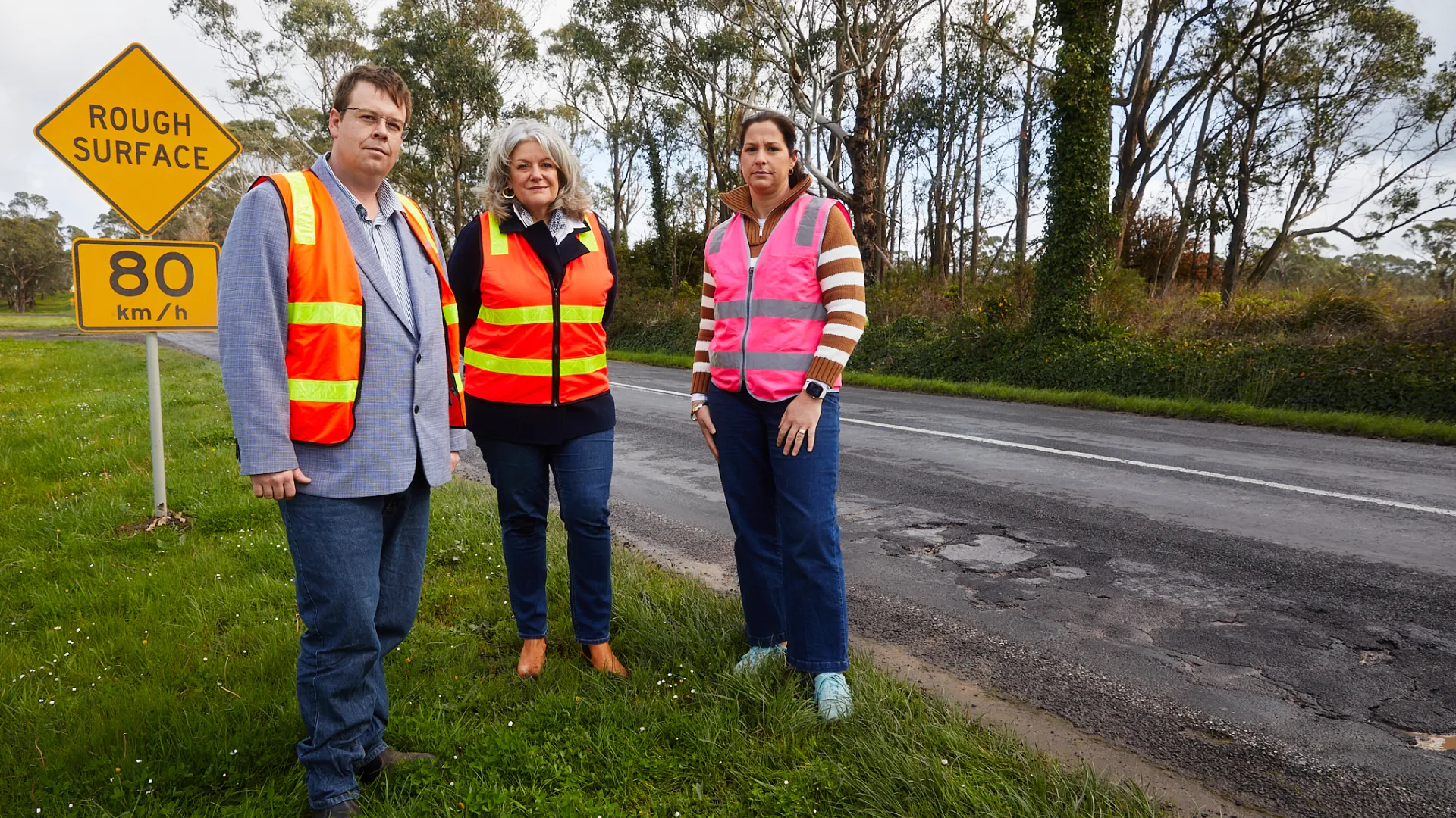 Councillors along a shabby stretch of road.