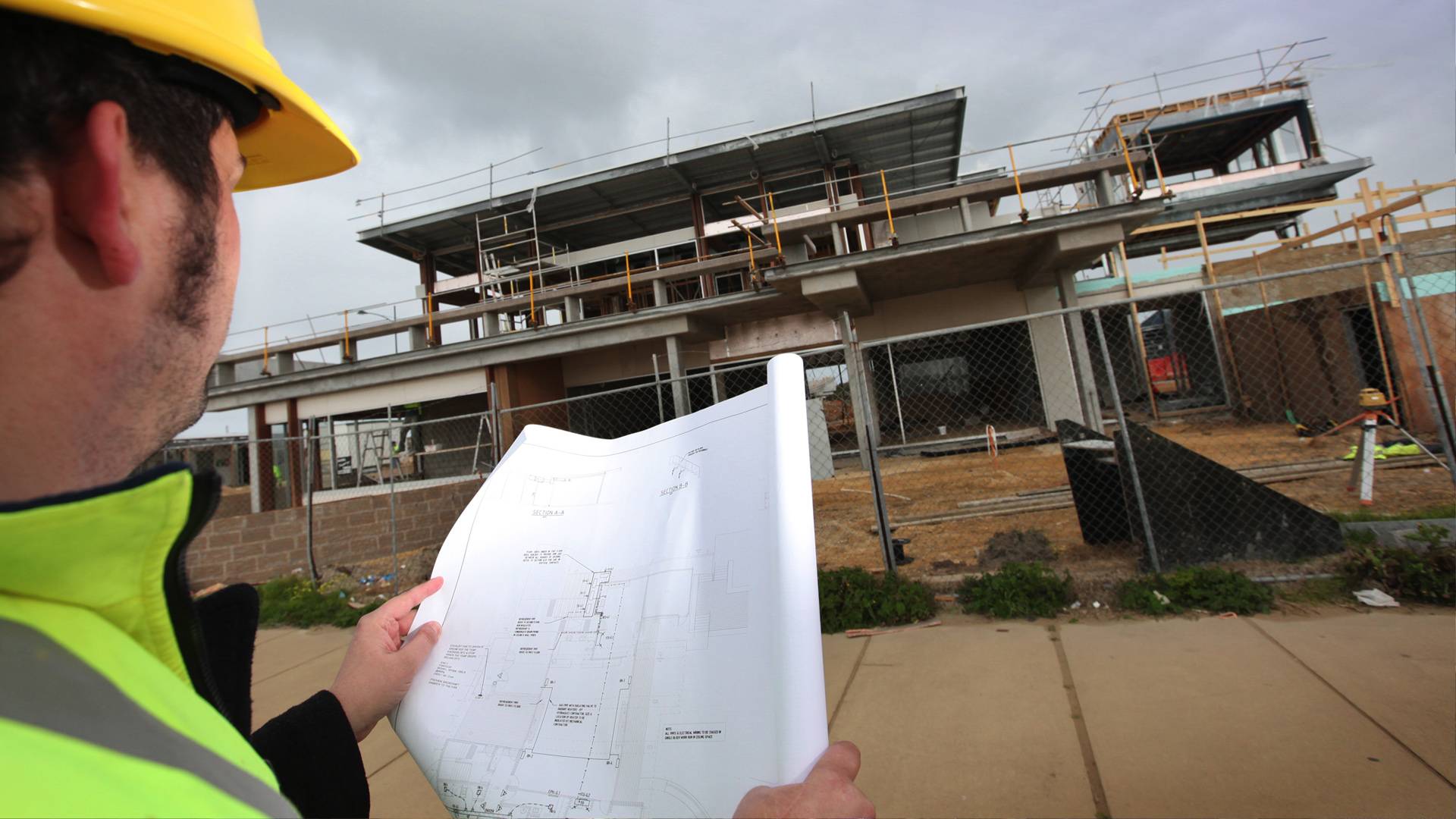 Workman looking at Plans