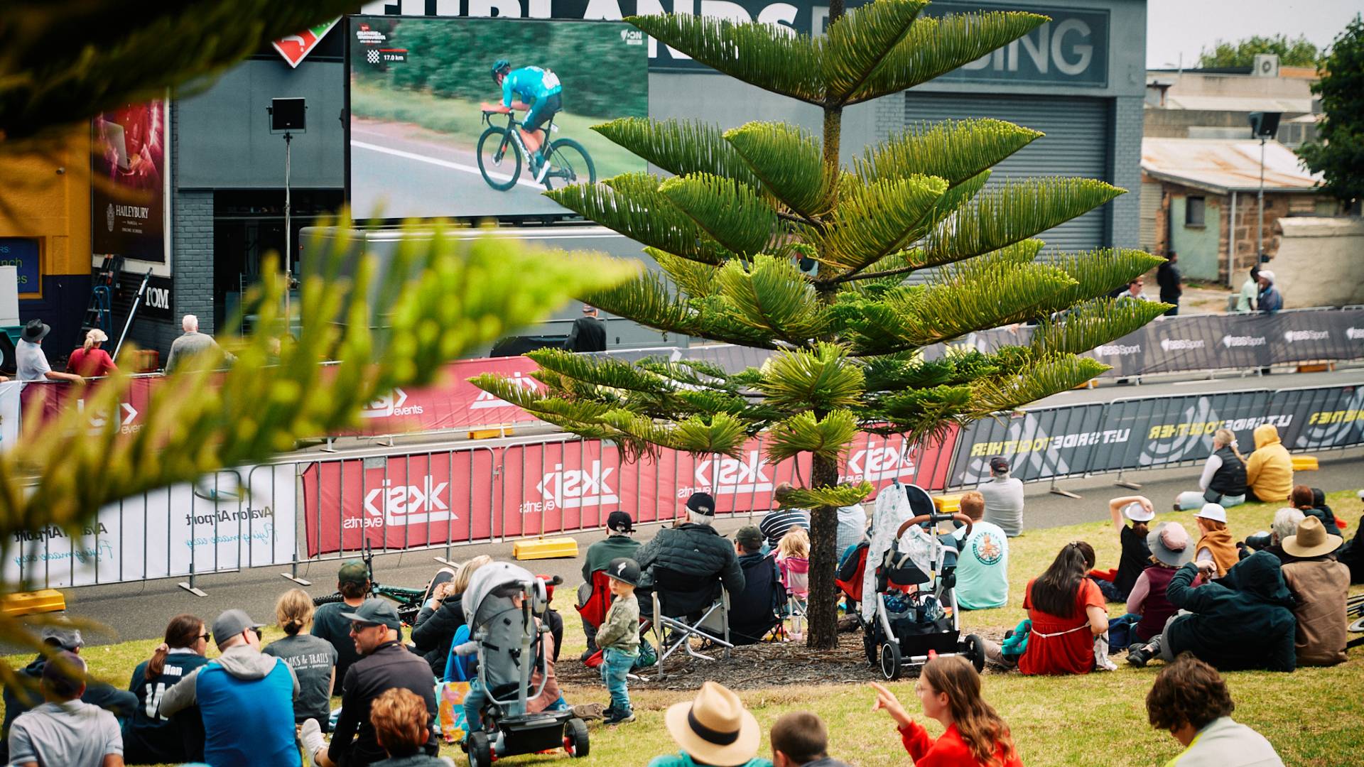 Crowd watches race progress on the big screen.