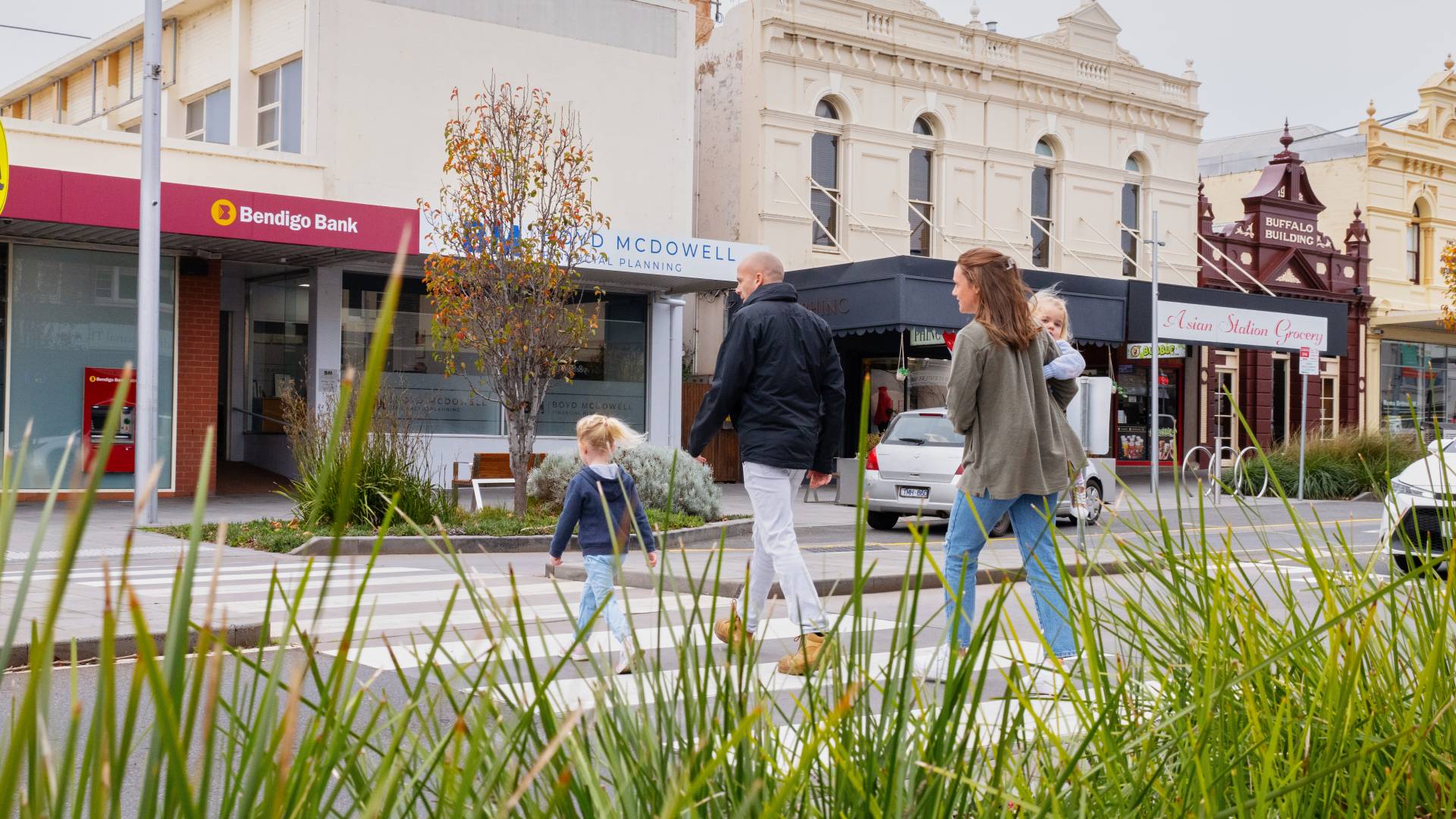 Young family crossing a street in Warrnambool's city centre.