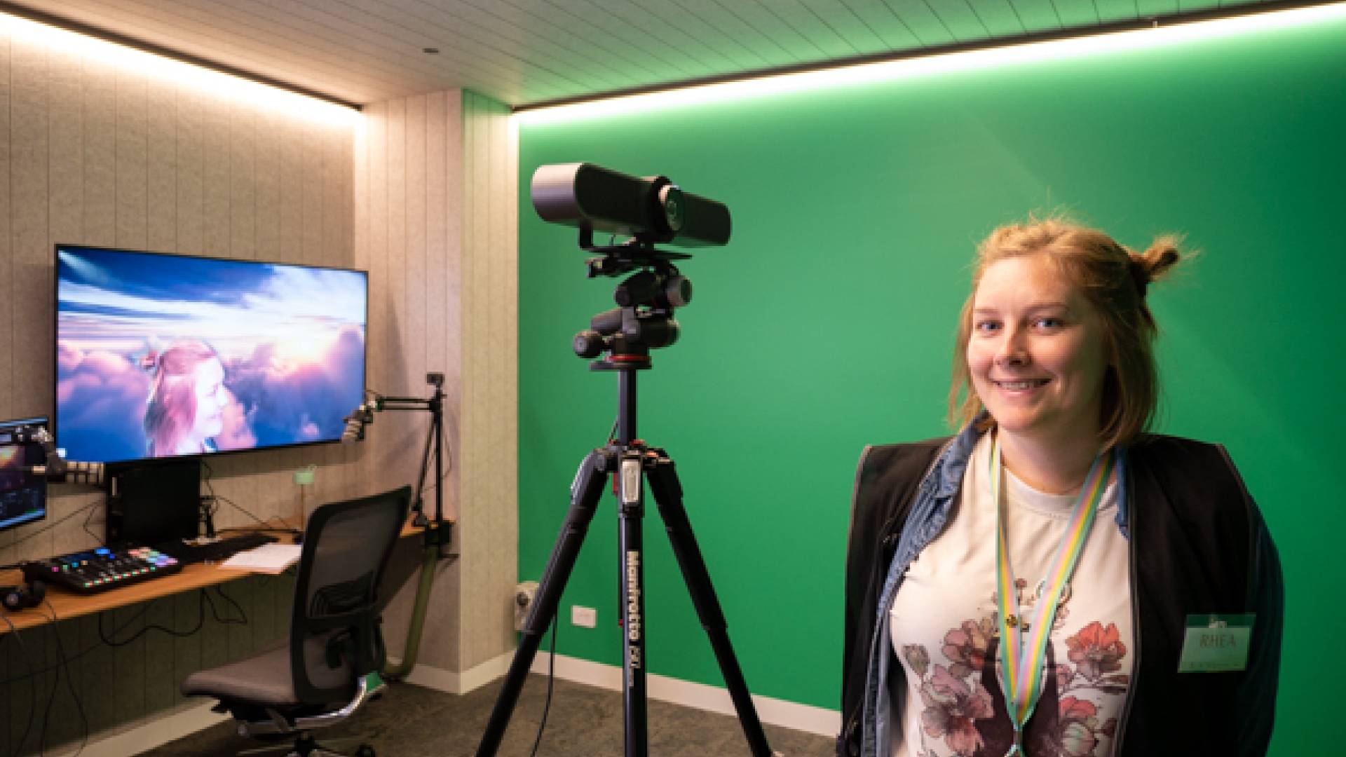 Digital Tech Programs Library Officer Rhea Kirkwood in the Sound Booth which has a green screen.