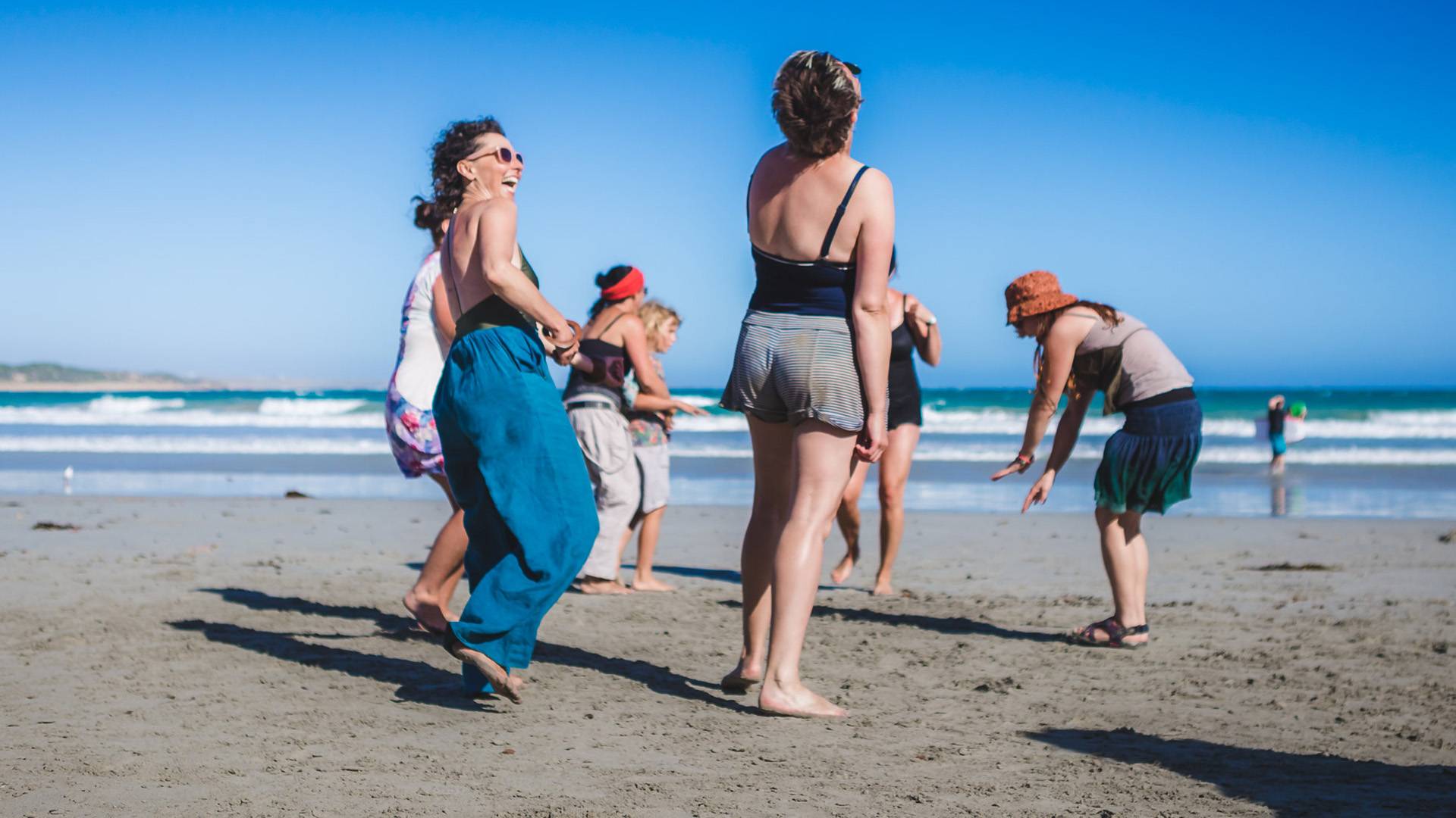 People on beach laughing