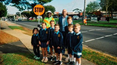 Crossing Supervisor Timothy Chirimuuta, Cr Billy Edis and St Joseph's Primary School students