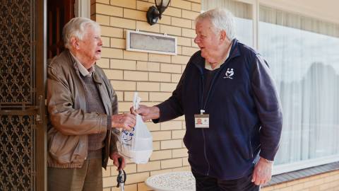 Meals on Wheels client Jimmy Cathcart with volunteer John Palmer