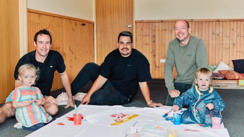 Chris Campbell and his daugher Niamh, group facilitator Sona Tuakalau, and Dion Barker with his son Finlay