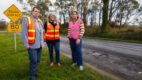 Councillors along a shabby stretch of road.