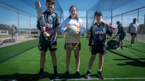 West Warrnambool Cricket Club players Beau Gannon and Cooper McDonald with Old Collegians netballer Addison Holcombe (centre)