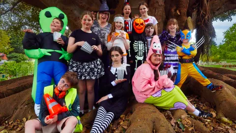 Cr Debbie Arnott with a spooky group of children, excited for Halloween