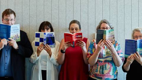 Library crew and mayor reading books.