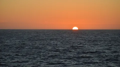 Sun setting beyond the Southern Ocean.