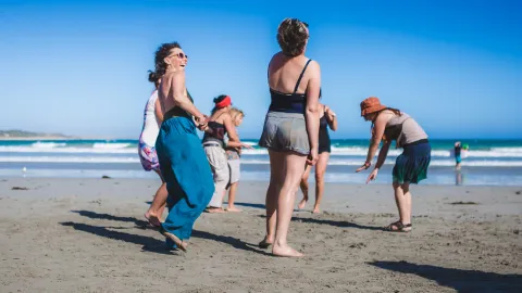 People on beach laughing